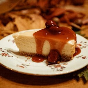 A mouthwatering slice of cheesecake topped with caramel and berries, ideal for dessert lovers.